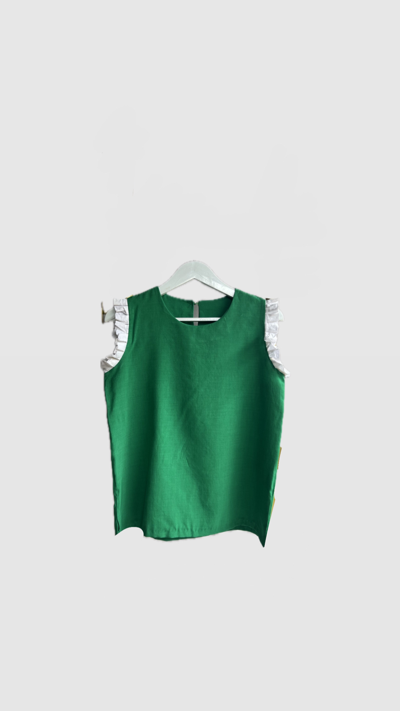Green Sleeveless Top with White Ruffle Detail